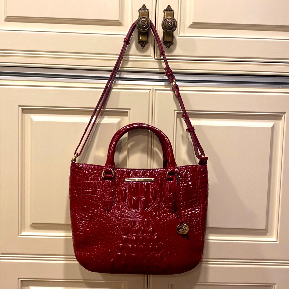This is a like new  small Lena Brahman, red wine, colored shoulder bag.